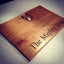 Bespoke solid oak breadboard with bronze stag casting and engraved lettering for The Mighty Stag hotel, made by Mungo and Co in West Yorkshire
